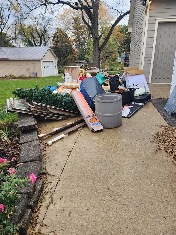 Dumpster being loaded with debris for 12 Yard Dumpster Rental in DeWitt